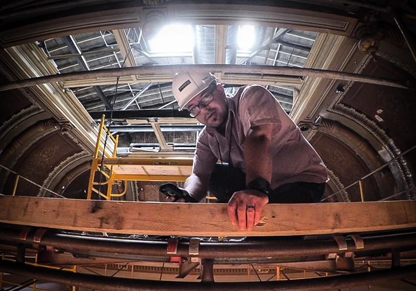 Gio Toninelo investigates and tests a timelapse camera at the Colorado State Capitol