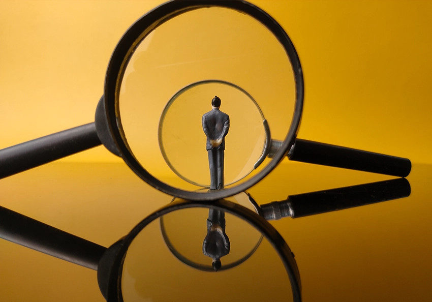 mini figure in front of a magnifying glass