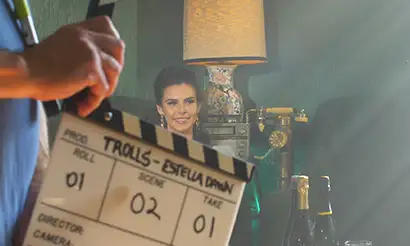 A camera assistant prepares to slate a scene.