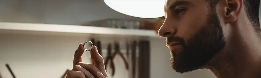 A jeweler shows off a ring during a product video.